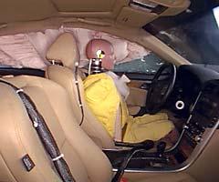 Action shot taken during the side impact crash test showing the driver dummy's head was protected from being hit by hard structures by the side curtain airbag