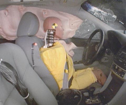 Action shot taken during the side impact crash test showing the driver dummy's head was protected from being hit by hard structures by the side curtain airbag