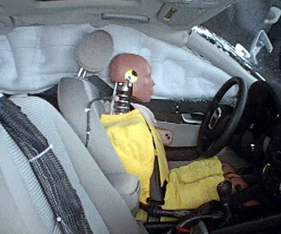 Action shot taken during the side impact crash test showing the driver dummy's head was protected from being hit by hard structures by the side curtain airbag