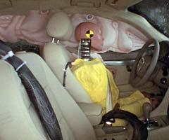 Action shot taken during the side impact crash test showing the driver dummy's head was protected from being hit by hard structures by the side curtain airbag