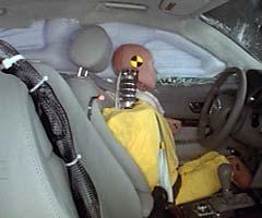 Action shot taken during the side impact crash test showing the driver dummy's head was protected from being hit by hard structures by the side curtain airbag