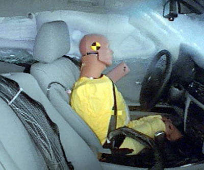 Action shot taken during the side impact crash test showing the driver dummy's head was protected from being hit by hard structures by the side curtain airbag