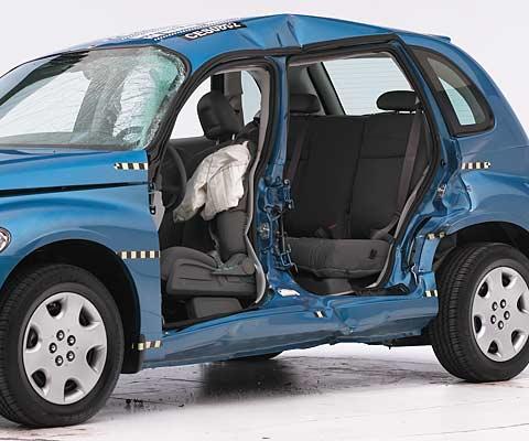 View of the vehicle after the crash with doors removed, showing the side airbag and damage to the occupant compartment