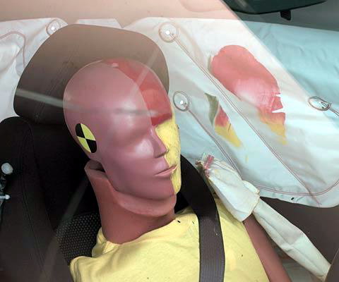 Action shot taken during the side impact crash test showing the driver dummy's head was protected from being hit by hard structures by the side curtain airbag.