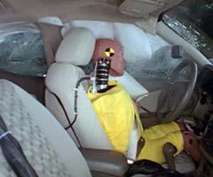 Action shot taken during the side impact crash test showing the driver dummy's head was protected from being hit by hard structures by the side curtain airbag.