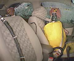 Action shot taken during the side impact crash test showing the driver dummy's head being hit by the intruding barrier.