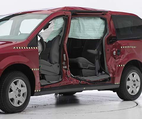 View of the vehicle after the crash with doors removed, showing the side airbag and damage to the occupant compartment