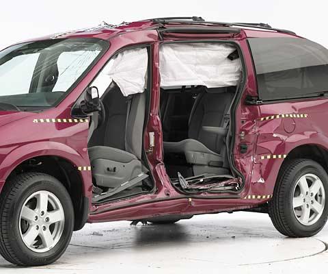 View of the vehicle after the crash with doors removed, showing the side airbag and damage to the occupant compartment