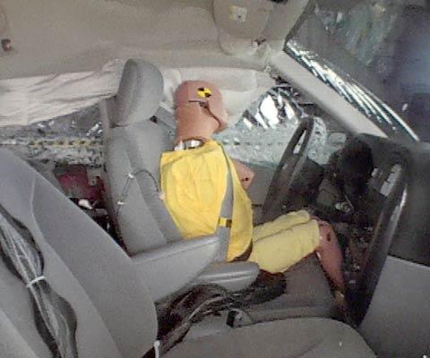 Action shot taken during the side impact crash test showing the driver dummy's head was protected from being hit by hard structures by the side curtain airbag