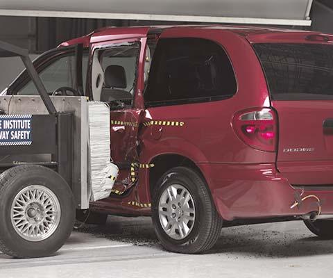 View of the vehicle after the crash with doors removed, showing the side airbag and damage to the occupant compartment