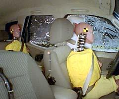 Action shot taken during the side impact crash test showing the driver dummy's head was protected from being hit by hard structures by the side airbags