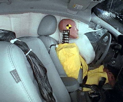 Action shot taken during the side impact crash test showing the driver dummy's head was protected from being hit by hard structures by the side curtain and side torso airbags.