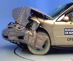 Crumpled sheet metal in front of the occupant compartment indicates where the crash energy was absorbed. A strong safety cage helped keep the tire out of the driver footwell area