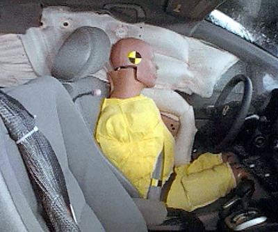 Action shot taken during the side impact crash test showing the driver dummy's head was protected from being hit by hard structures by the side curtain airbag