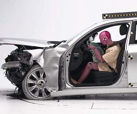 The dummy's position in relation to the steering wheel and instrument panel after the crash test indicates that the driver's survival space was maintained well (first test shown)