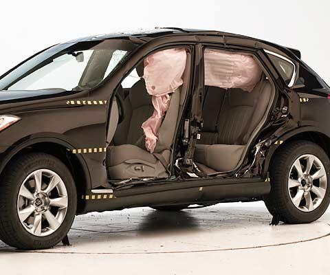 View of the vehicle after the second crash with doors removed, showing the side airbags and damage to the occupant compartment.