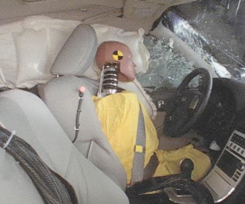 Action shot taken during the side impact crash test showing the driver dummy's head was protected from being hit by hard structures by the side curtain airbag