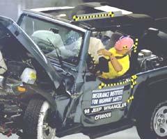 The dummy's head and left shoulder leaned out of the vehicle after rebounding from the airbag. The problem is the driver door, which is too low to restrain the dummy optimally