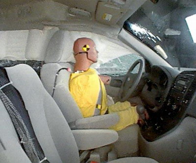 Action shot taken during the side impact crash test showing the driver dummy's head was protected from being hit by hard structures by the side curtain airbag.