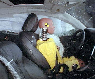 Action shot taken during the side impact crash test showing the driver dummy's head was protected from being hit by hard structures by the side curtain airbag.