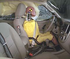 Action shot taken during the side impact crash test showing the driver dummy's head was protected from being hit by hard structures by the side airbags