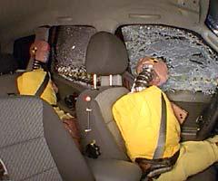 Action shot taken during the side impact crash test showing the driver dummy's head was protected from being hit by hard structures by the side airbags