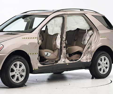 View of the vehicle after the second crash with doors removed, showing the side airbags and damage to the occupant compartment