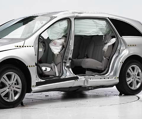 View of the vehicle after the second crash with doors removed, showing the side airbags and damage to the occupant compartment