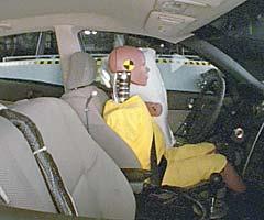 Action shot taken during the side impact crash test showing the driver dummy's head was protected from being hit by hard structures by the side airbag