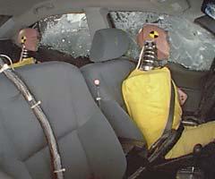 Action shot taken during the side impact crash test showing the driver dummy's head being hit by the intruding barrier