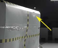 A noticeable dent indicates where the driver dummy's head hit the barrier