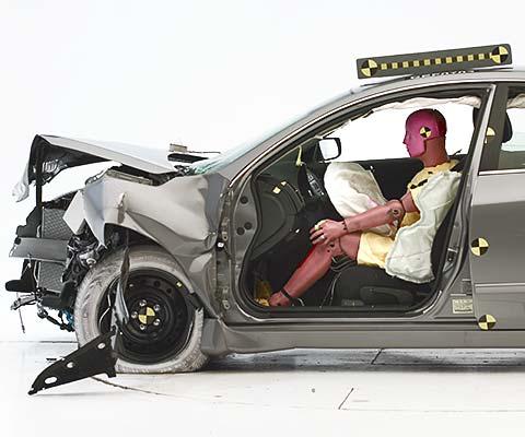 The dummy's position in relation to the steering wheel and instrument panel after the crash test indicates that the driver's survival space was maintained well (Institute test car shown)