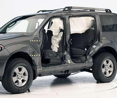 View of the vehicle after the crash with doors removed, showing the damage to the occupant compartment