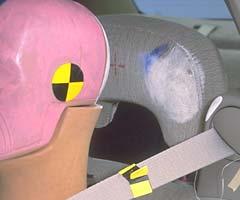 Smeared greasepaint indicates where the dummy's head hit the head restraint and shoulder belt housing during rebound. Front lap/shoulder belts are mounted to the seats