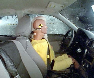 Action shot taken during the side impact crash test showing the driver dummy's head was protected from being hit by hard structures by the side curtain airbag.