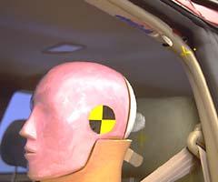 Pink, white, and blue paint above the dummy's head shows where it hit the roof rail after rebounding from the airbag