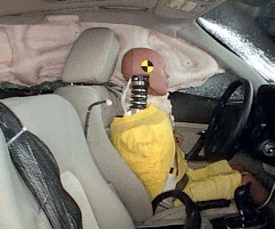 Action shot taken during the side impact crash test showing the driver dummy's head was protected from being hit by hard structures by the side curtain airbag