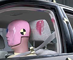 Smeared greasepaint indicates where the dummy's head hit the B-pillar, roof rail, and head restraint during rebound. Head accelerations from these hits were low