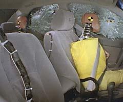 Action shot taken during the side impact crash test showing the driver dummy's head being hit by the intruding barrier