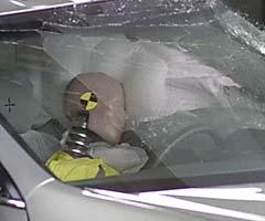 Action shot taken during the side impact crash test showing the driver dummy's head was protected from being hit by hard structures by the side curtain airbag