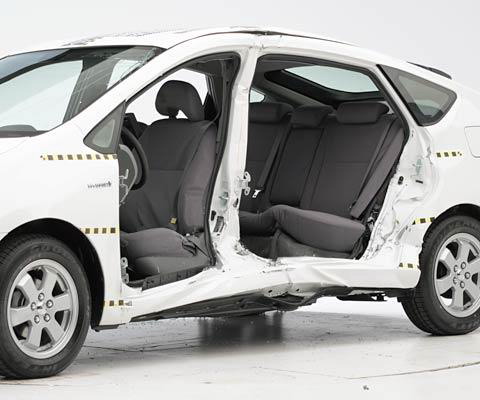 View of the vehicle after the crash with door removed, showing the side airbags and damage to the occupant compartment