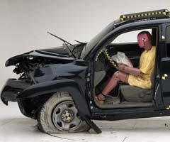 The dummy's position in relation to the steering wheel and instrument panel after the crash test indicates that the driver's survival space was maintained well (Institute test vehicle shown)