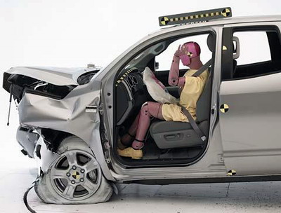 The dummy's position in relation to the steering wheel and instrument panel after the crash test indicates that the driver's survival space was maintained very well (Institute test vehicle shown)