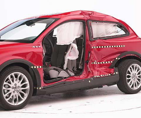 View of the vehicle after the crash with door removed, showing the side airbags and damage to the occupant compartment