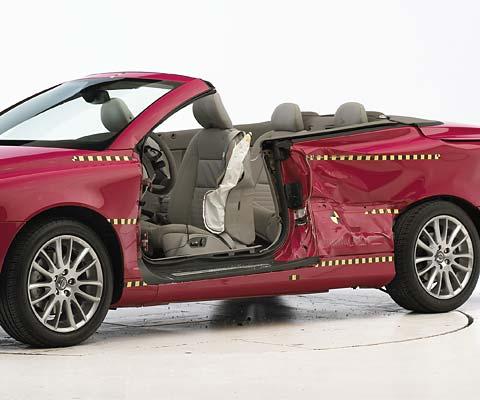 View of the vehicle after the crash with door removed, showing the side airbag and damage to the occupant compartment