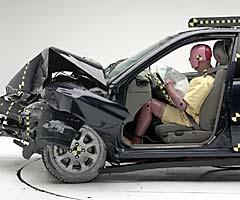 The dummy's position in relation to the steering wheel and instrument panel after the crash test indicates the driver's survival space was maintained well