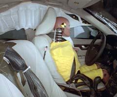 Action shot taken during the side impact crash test showing the driver dummy's head was protected from being hit by hard structures by the side airbags