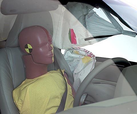 Action shot taken during the side impact crash test showing the driver dummy's head was protected from being hit by hard structures by the side airbags