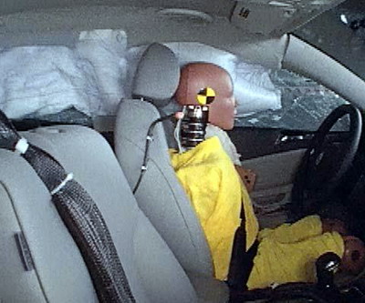 Action shot taken during the side impact crash test showing the driver dummy's head was protected from being hit by hard structures by the side curtain airbag